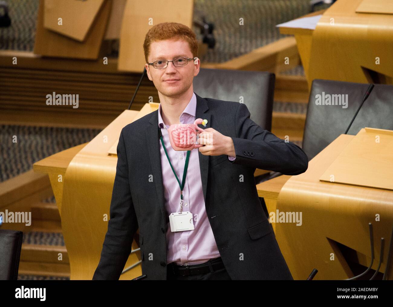 Edinburgh, UK. 7 November 2019. Pictured: Ross Greer MSP, Scottish green Party, holding a flamingo shaped mug of tea. The Scottish Green Party have halted the proposed development of Flamingo Land at Loch Lomond. Credit: Colin Fisher/Alamy Live news. Stock Photo