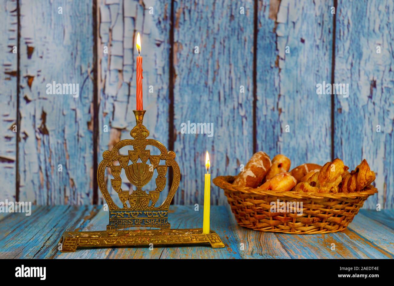 Lighting the first candle on a hanukkah of a burning Chanukah
