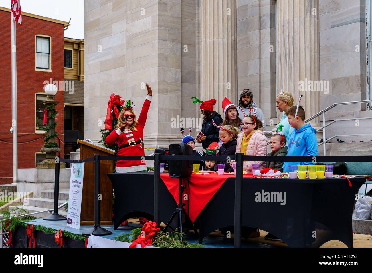 Gettysburg, PA / USA - December 7, 2019:  Children participate in Christmas Cookie eating contest on the steps of the public library in the downtown d Stock Photo