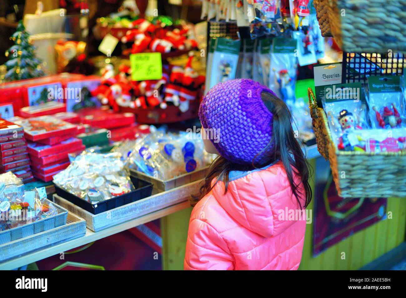 Chicago, Illinois, USA. Little girl observing the goods available at