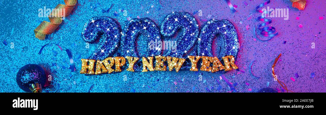 Sparkling new years 2020 3d letters with confetti and christmas bulbs - new years holiday concept image with copy space for text. Stock Photo