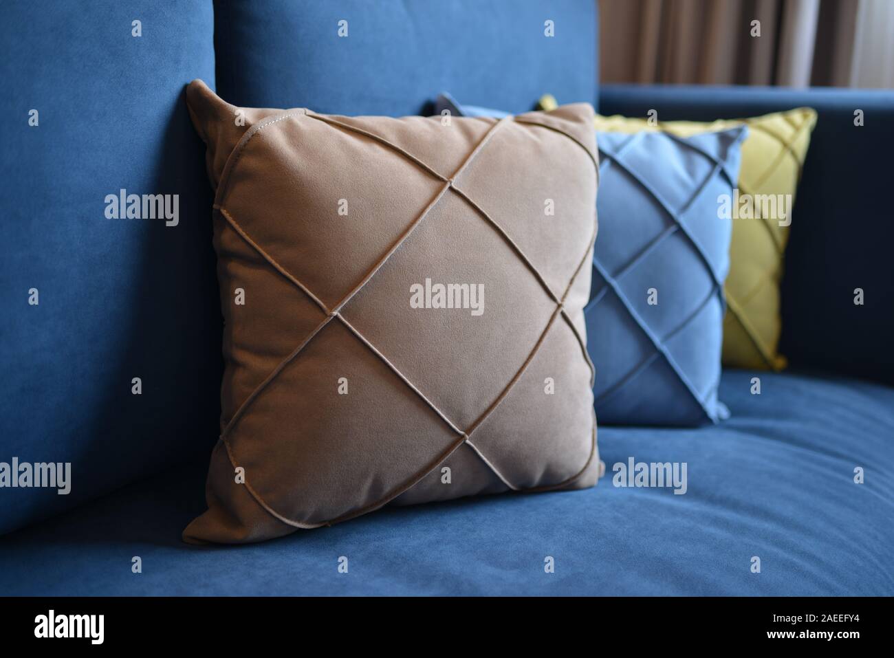 Brown Blue And Yellow Pillows On The Couch Stock Photo 335922024