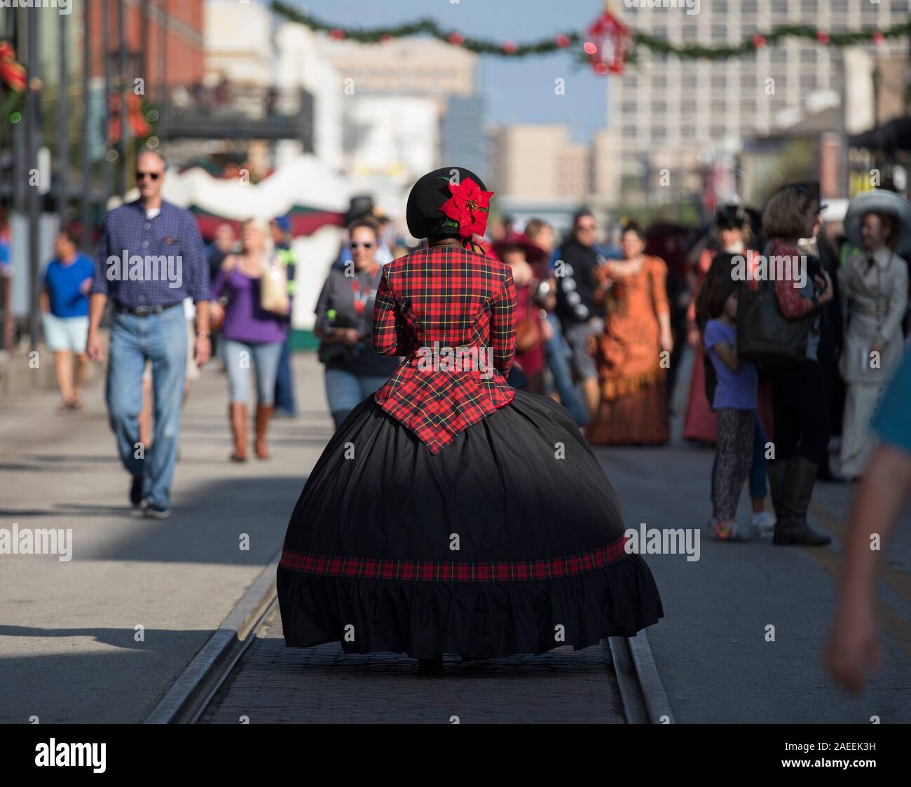 Galveston, USA. 8th Dec, 2019. A woman dressed in Victorian-era clothes participates in the 46th Annual Dickens on the strand in Galveston, Texas, the United States, on Dec. 8, 2019. The weekend-long festival is a famous Galveston holiday celebration. It features parades, races, circus performances, live music shows, bagpipe performances and even beard and mustache competition. Credit: Yi-Chin Lee/Xinhua/Alamy Live News Stock Photo