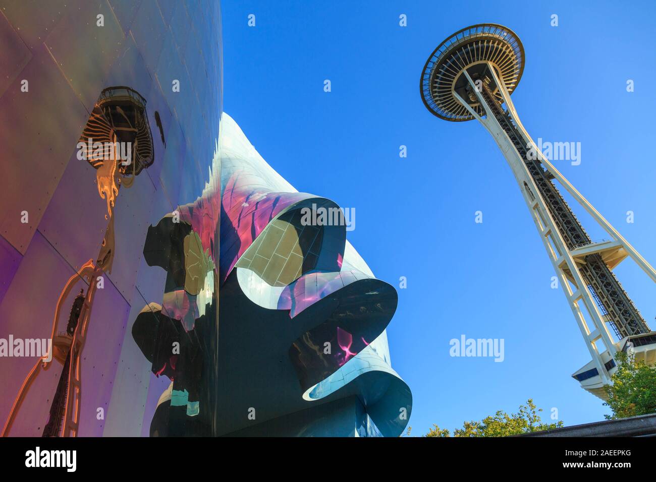 The Space Needle against the clear blue sky reflects on the Museum of Pop Culture(MOPOP) facade at Seattle Center, Seattle, Washington, USA. Stock Photo