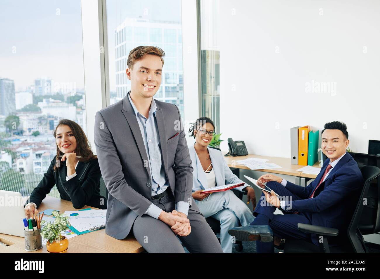 Happy young multi-ethnic business team working in modern office with ...