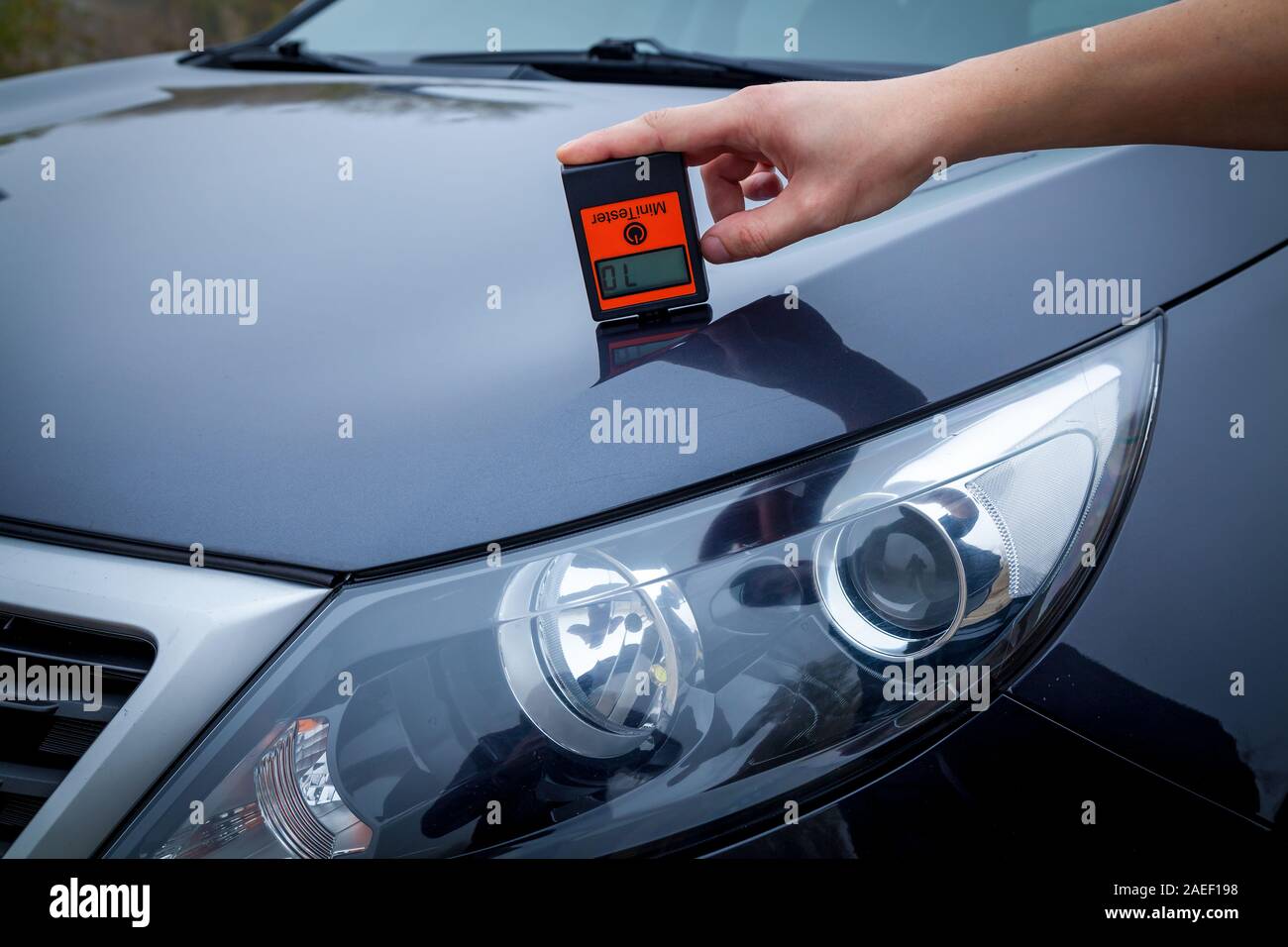Measuring the thickness of the car paint coating in black color using a