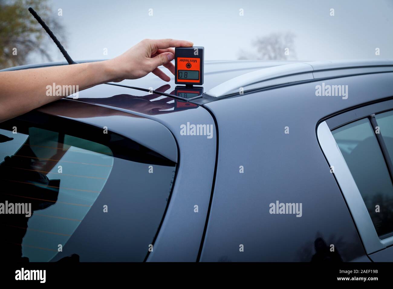 Measuring the thickness of the car paint coating in black color using a