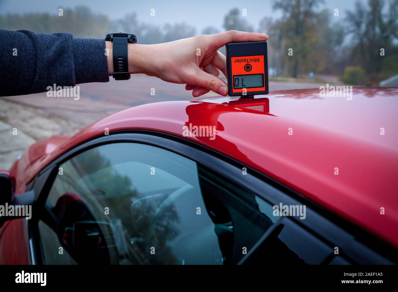 Measuring the thickness of the car paint coating red color using a