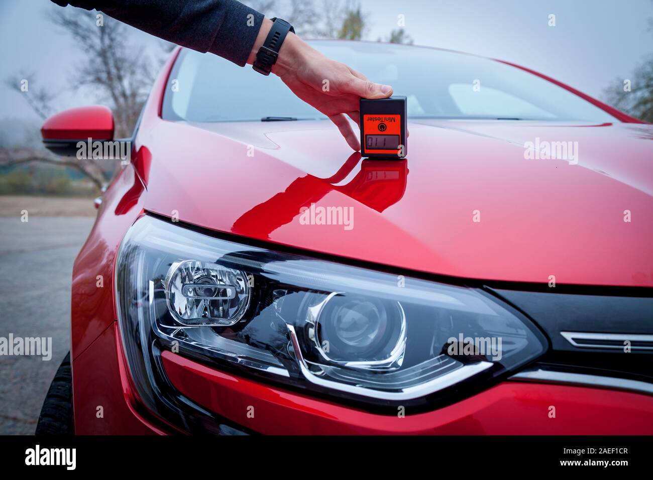 Measuring the thickness of the car paint coating red color using a