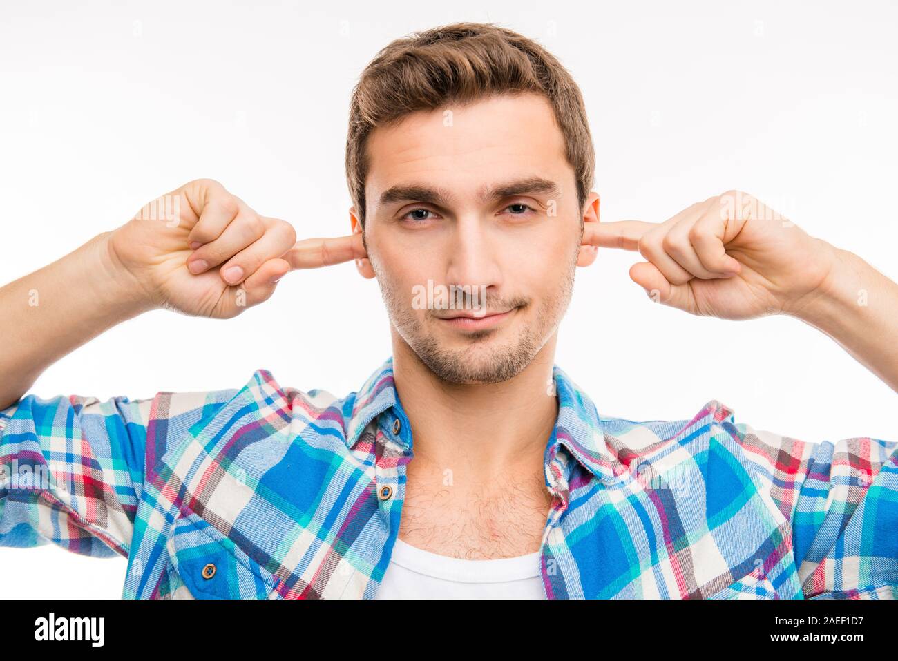 Covering his ears with hands ignoring hires stock photography and