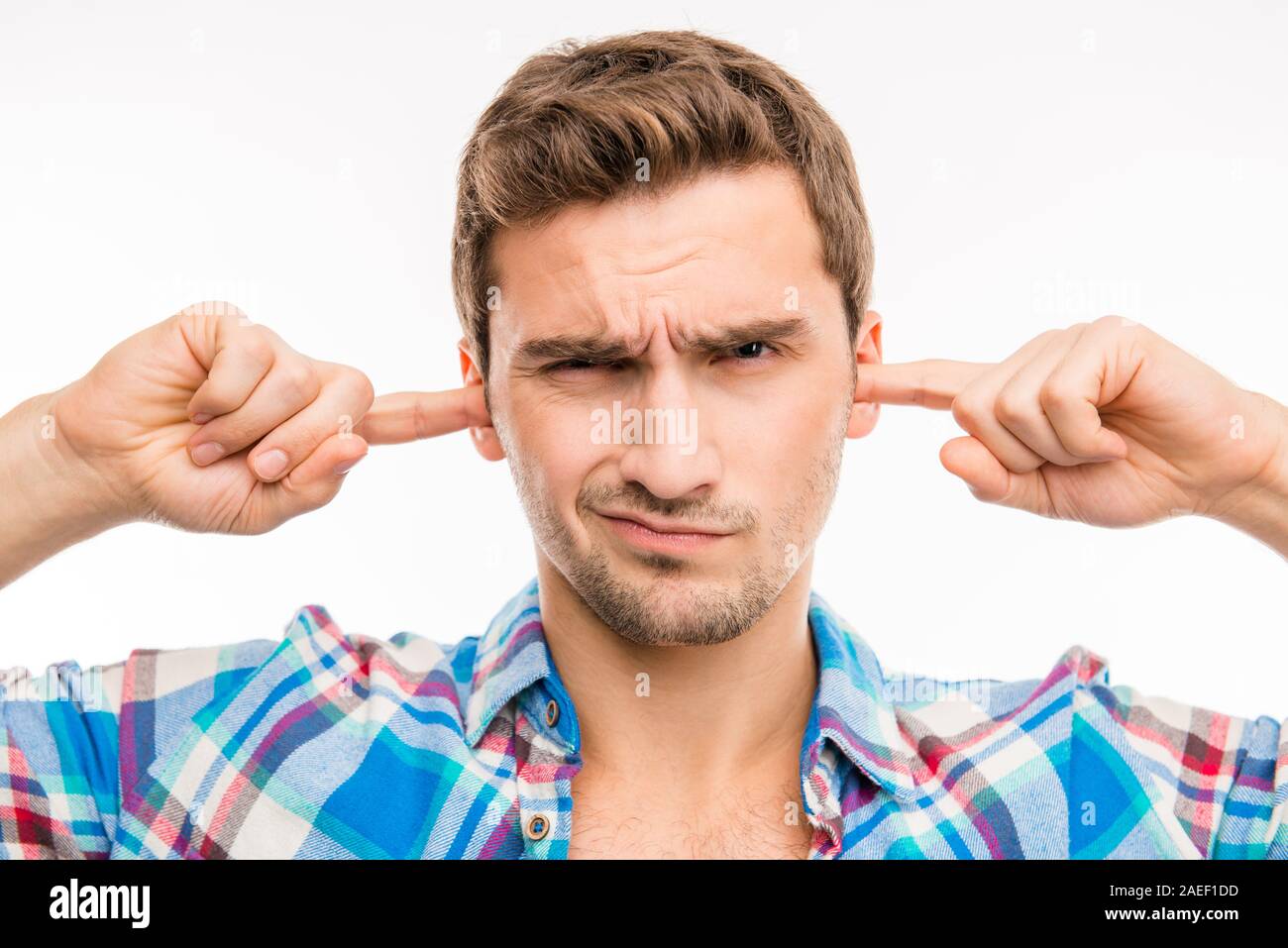 Young man covering his ears ignoring noise Stock Photo Alamy