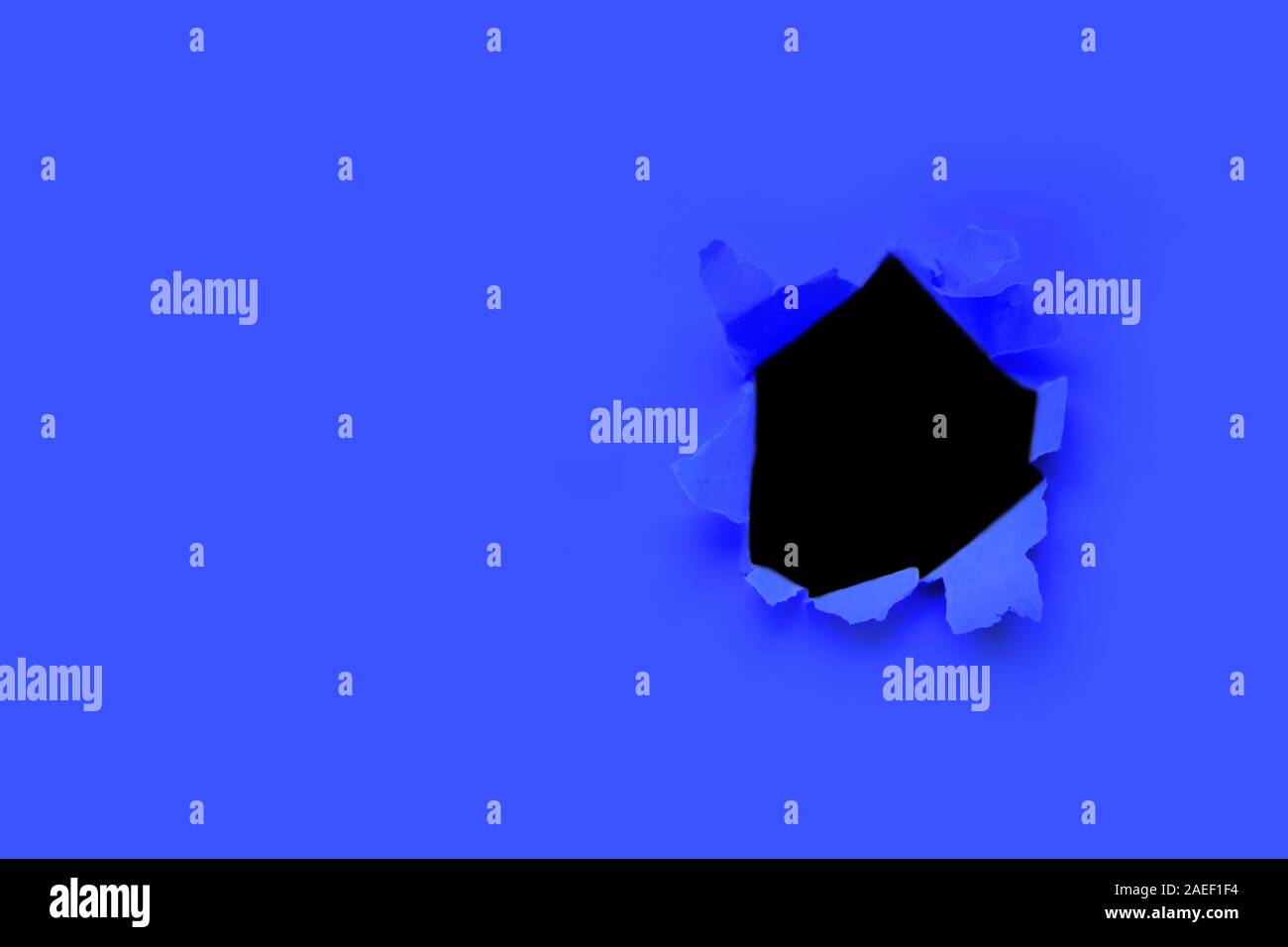 Breakthrough paper hole with black background toned with main trendy ...