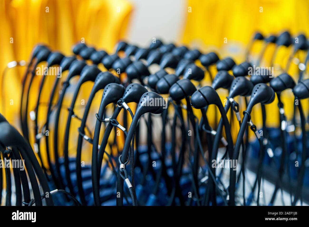 A lot of headphones are placed in rows. Stock Photo
