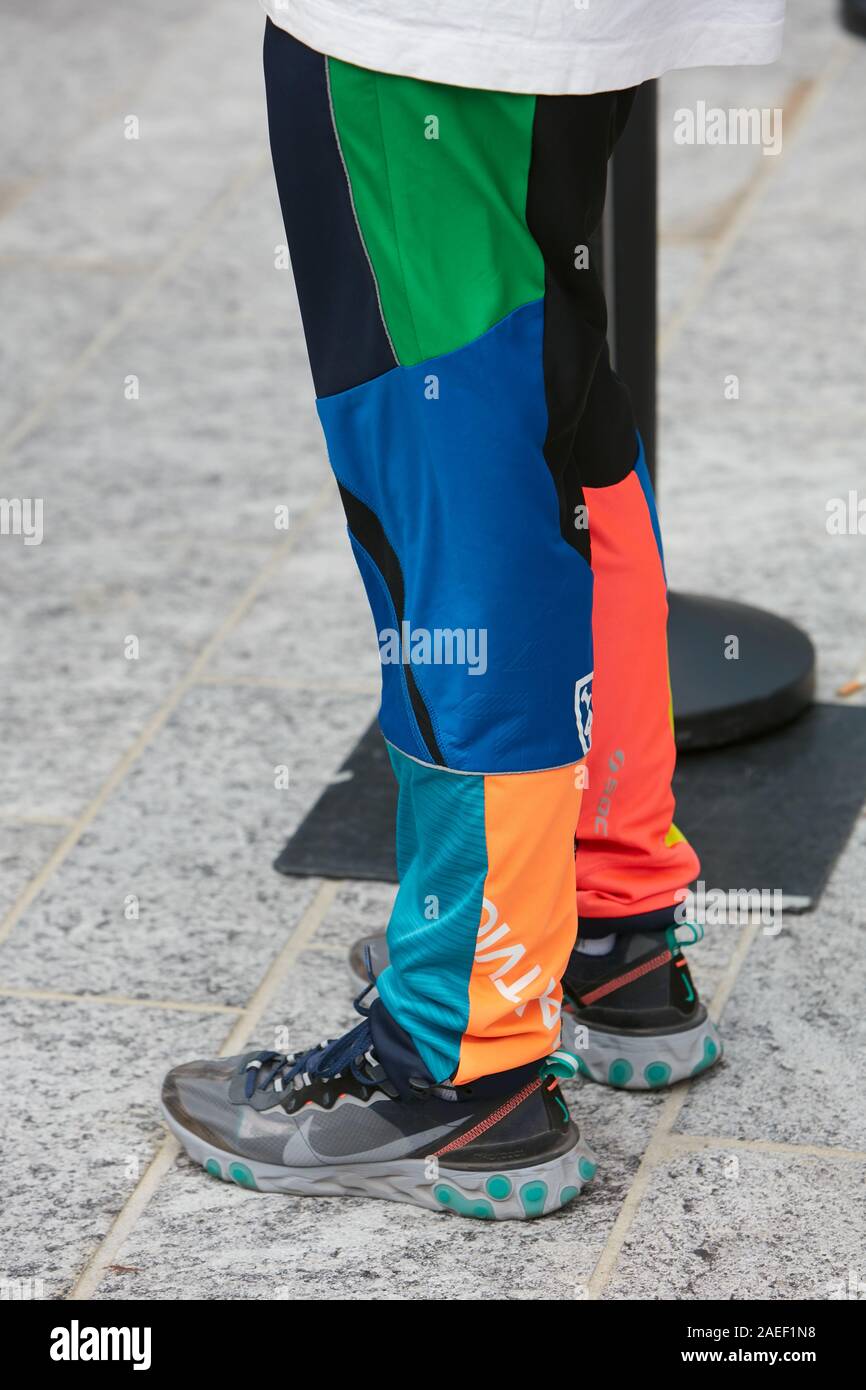 MILAN, ITALY - SEPTEMBER 20, 2019: Woman with gray Nike sneakers and  trousers in blue, orange, green and black colors before Sportmax fashion  show, Mi Stock Photo - Alamy