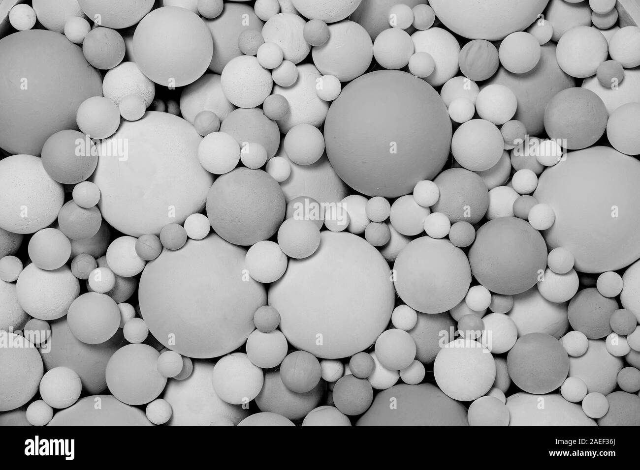 Black-white polystyrene beads of different sizes. Scenery black and white balls as a background. Texture round shape. Stock Photo