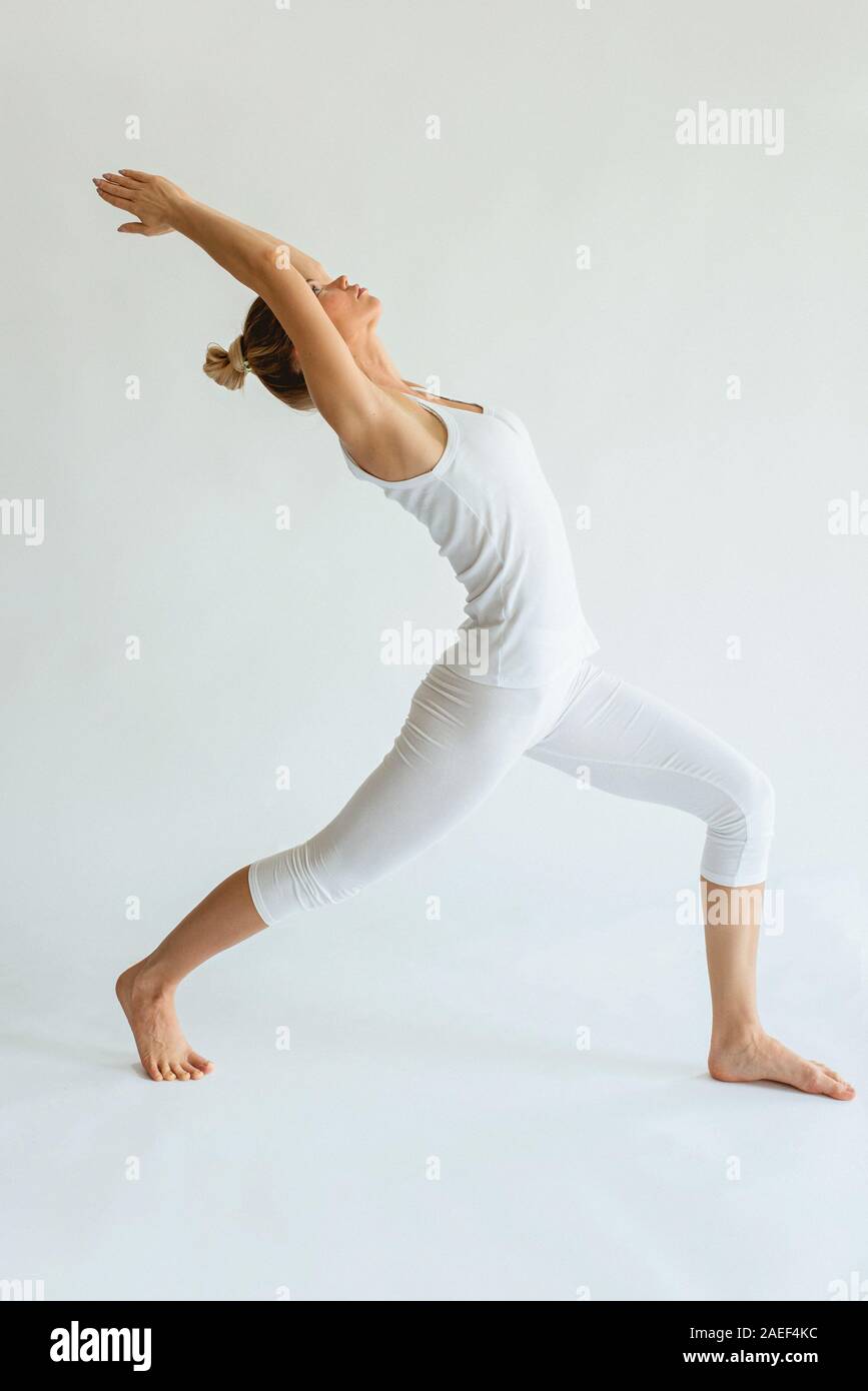 blonde cheerful woman doing yoga asanas. Healthy lifestyle and sport concept Stock Photo