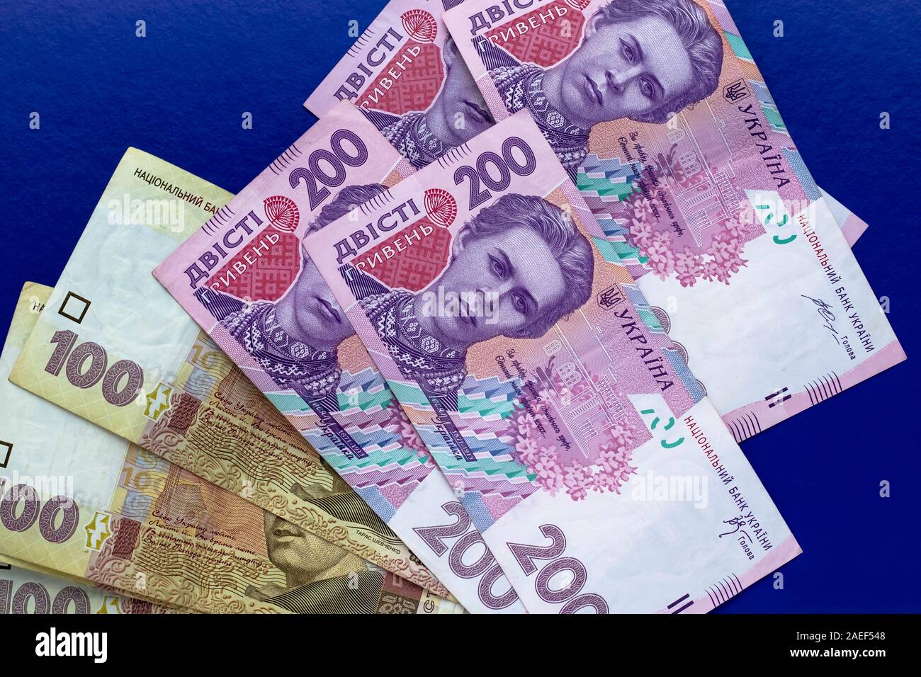 Ukrainian money, uah. Heap of banknotes on dark blue background. Cash of ukrainian hryvnia Stock Photo