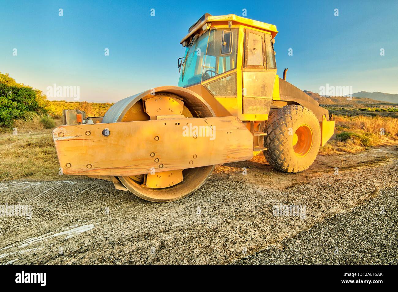Side view of steamroller in a suggestive construction site. Concept of work in progress. Stock Photo