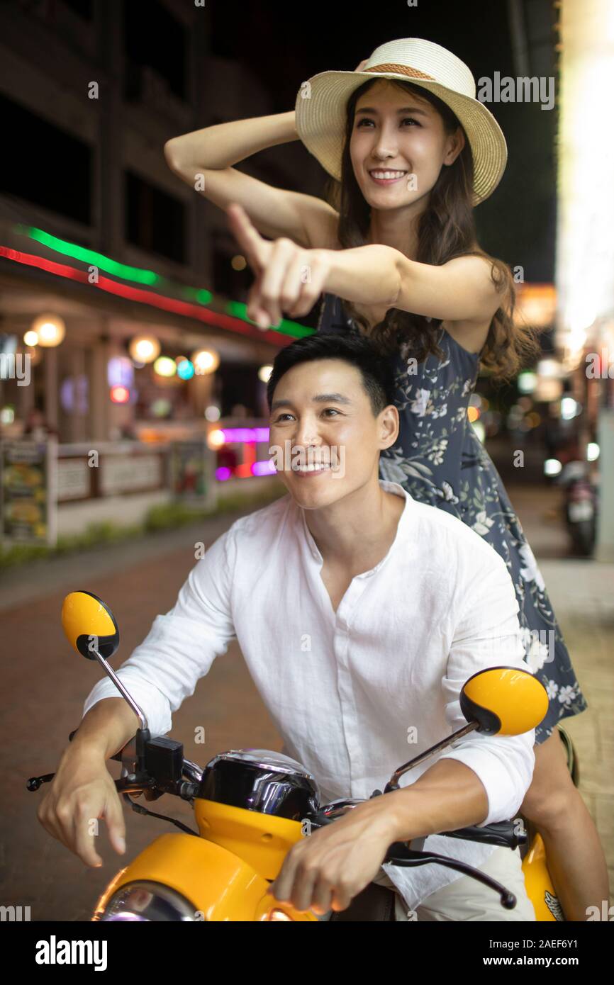 Happy young couple riding motorcycle together Stock Photo - Alamy