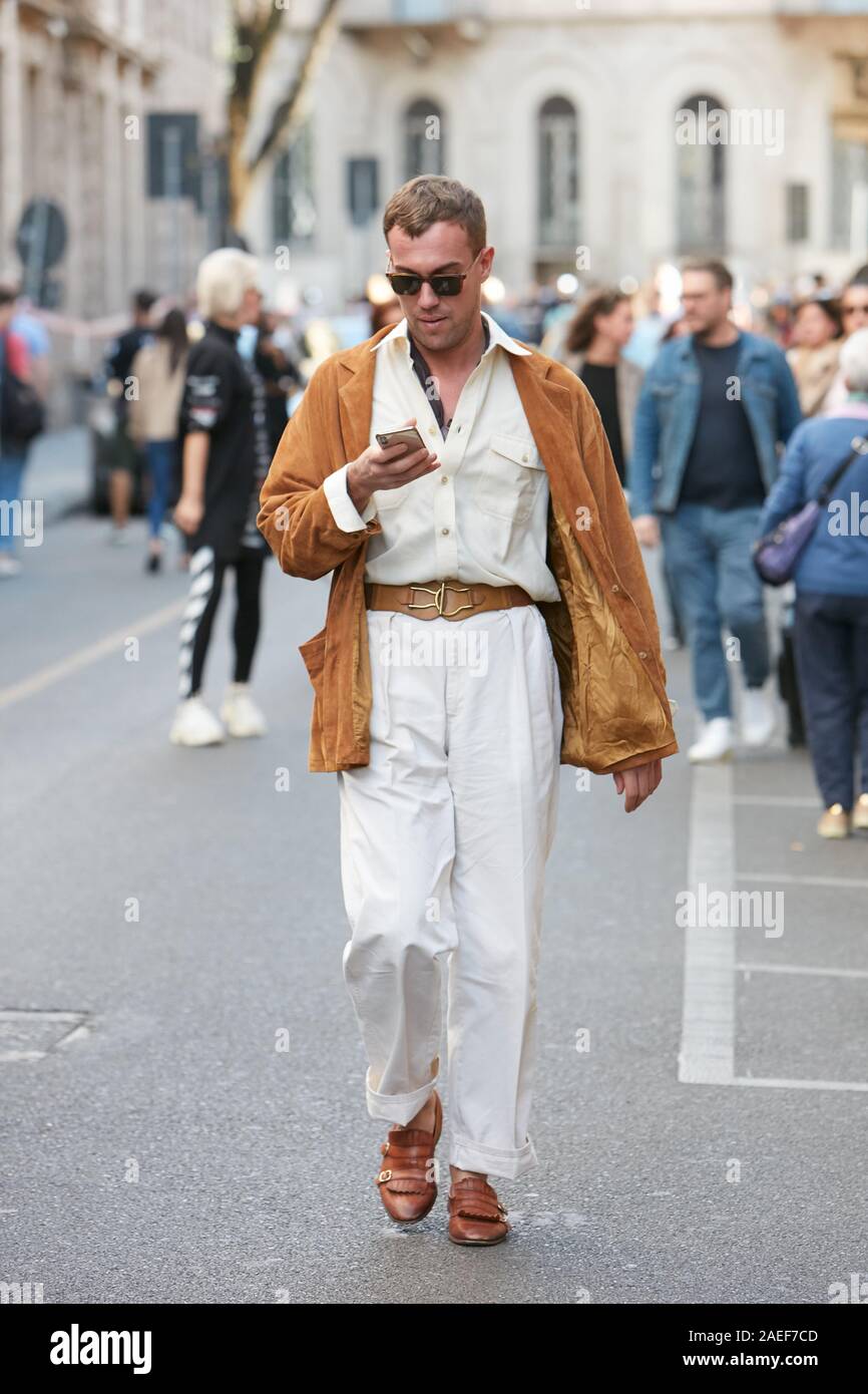 MILAN - JUNE 18: Man with brown Louis Vuitton bag and blue Gucci jacket  with yellow edge before Giorgio Armani fashion show, Milan Fashion Week  street Stock Photo - Alamy