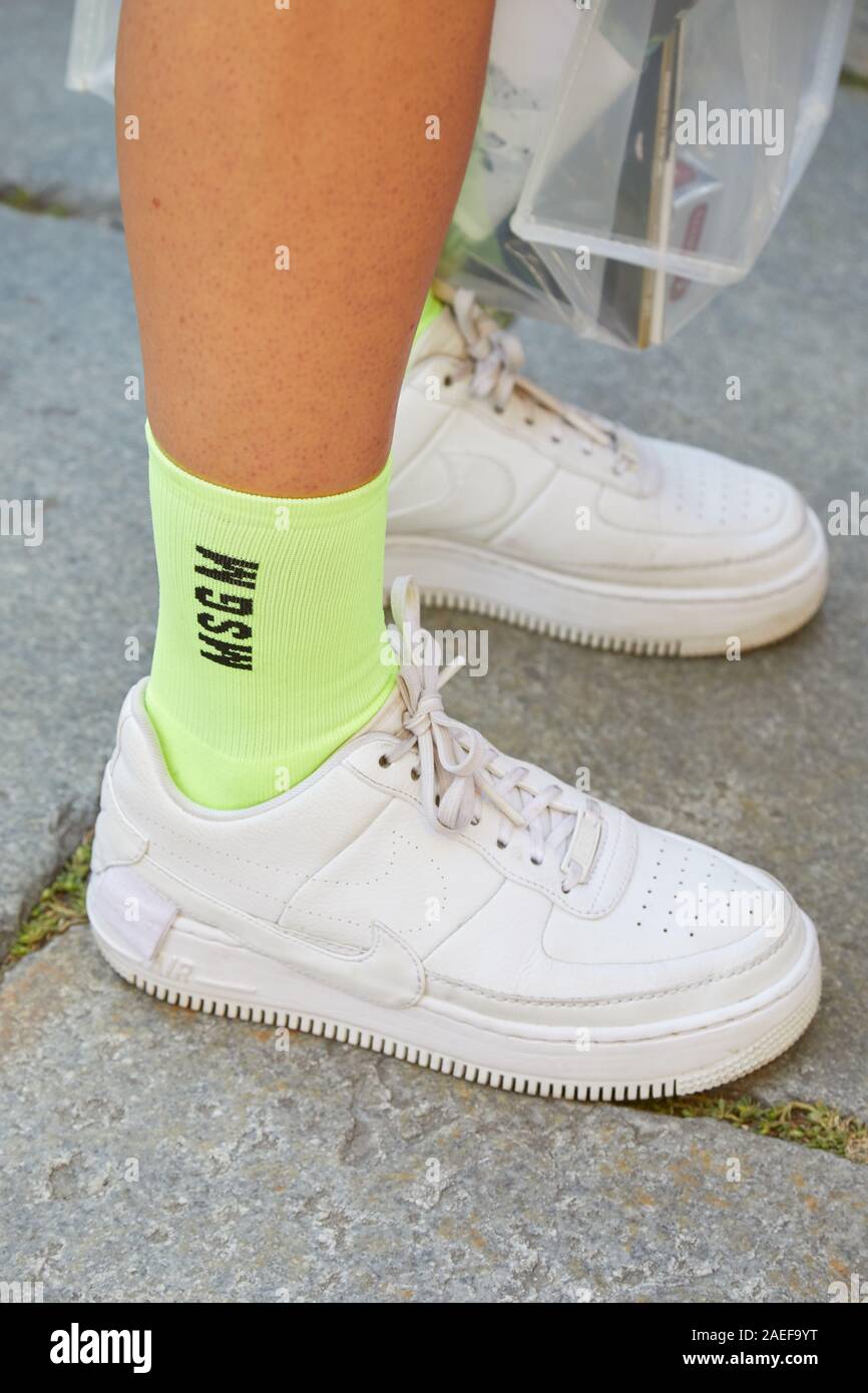 MILAN, ITALY - SEPTEMBER 21, 2019: Woman with white Nike sneakers and  yellow Msgm socks before Msgm fashion show, Milan Fashion Week street style  Stock Photo - Alamy