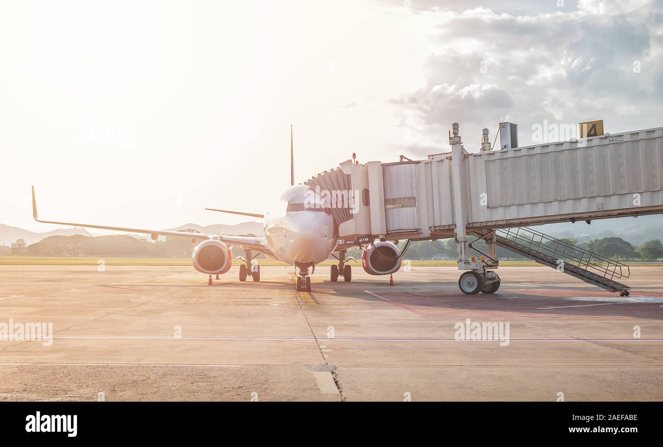 jet bridge or aerobridge connects the airplane’s door to the airport terminal, shelters for passengers disembark from an aircraft to the airport gate Stock Photo