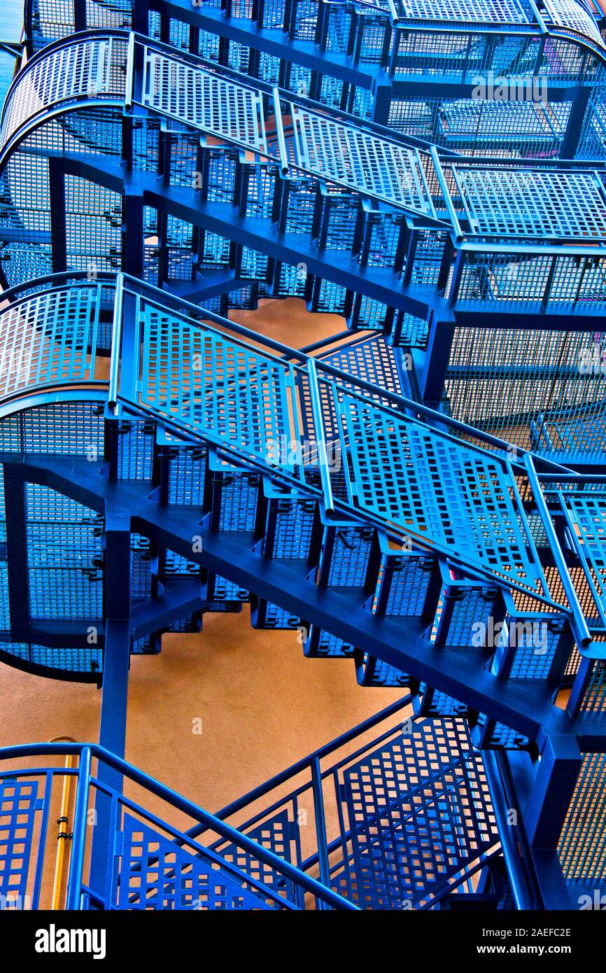 detail of a blue exterior staircase on a yellow building Stock Photo