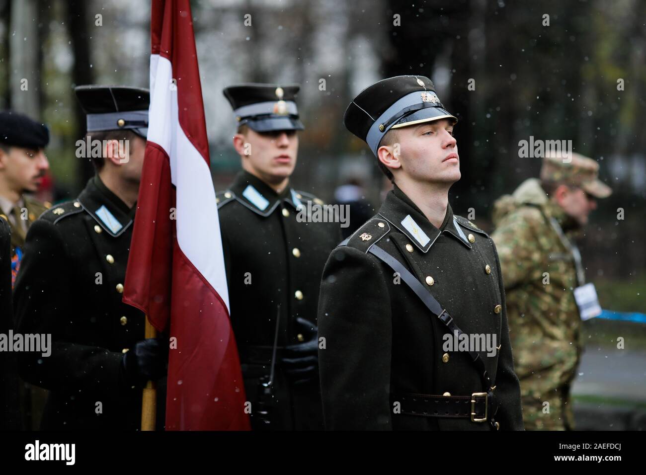 Bucharest, Romania - December 01, 2019: Latvian soldiers in ceremonial uniforms take part at the Romanian National Day military parade during a snowy Stock Photo