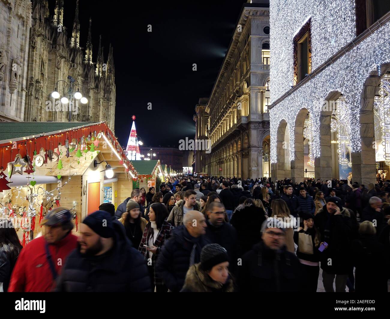Milan, Italy - December 7, 2019 Blurred people visit the traditional Christmas Market at the Corso Vittorio Emanuele next to the Duomo in Milan Stock Photo