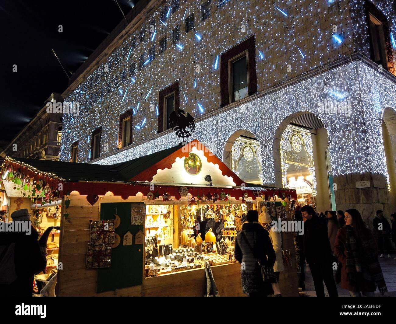 Milan, Italy - December 7, 2019 Kiosk of the traditional Chrisstmas Market in Corso Vittorio Emanuele in Milan with the Christmas Light of the Rinasce Stock Photo