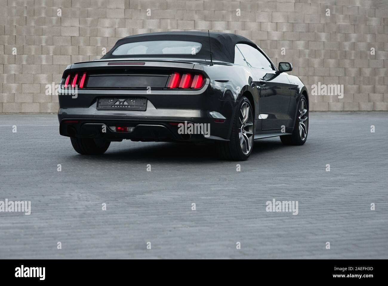 Gray american muscle car Ford Mustang GT with modifications standing alnone at city mall's parking. Stock Photo