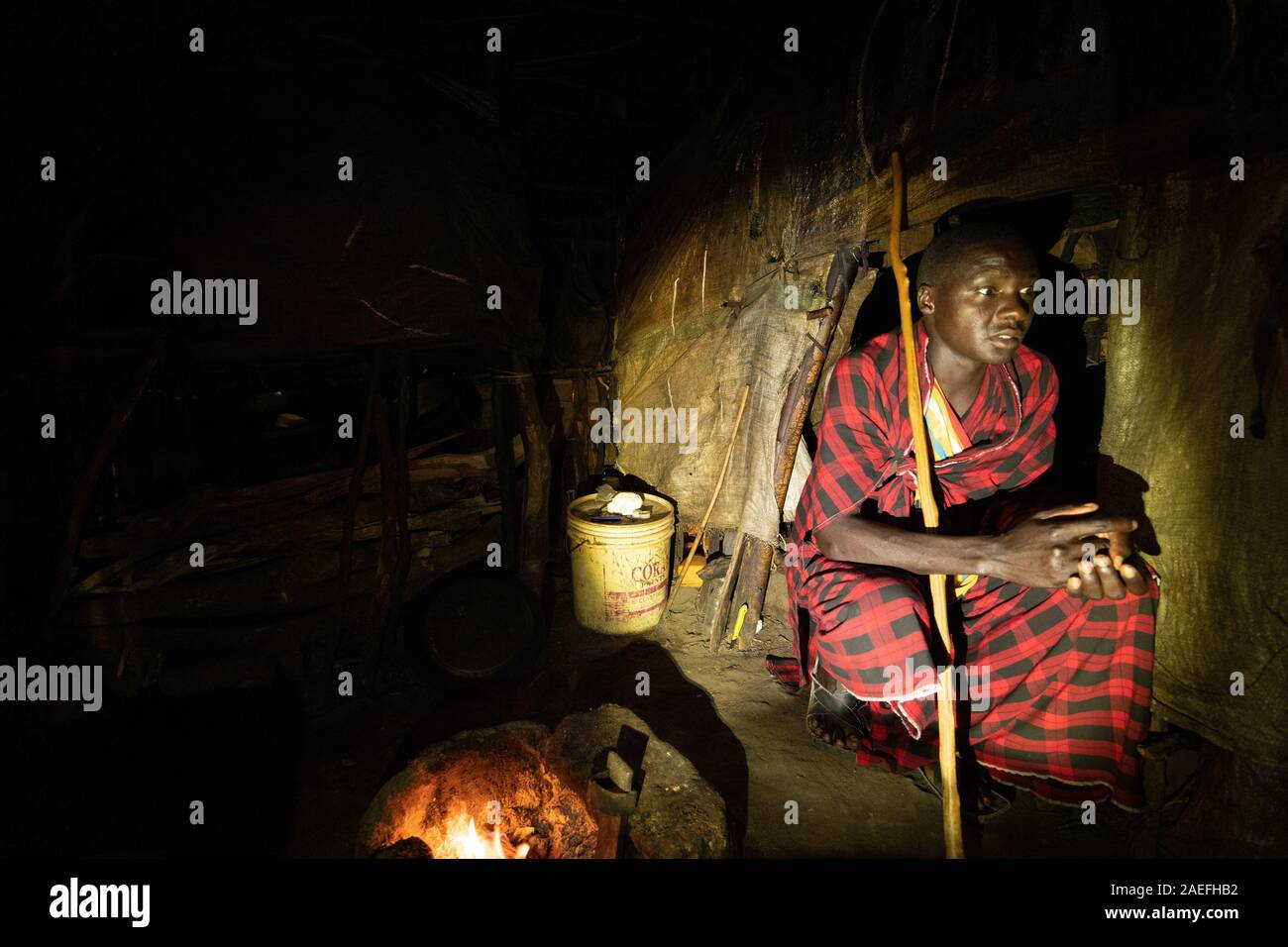 A Masai man is sitting in his house in Masai Village in Tanzania Stock Photo