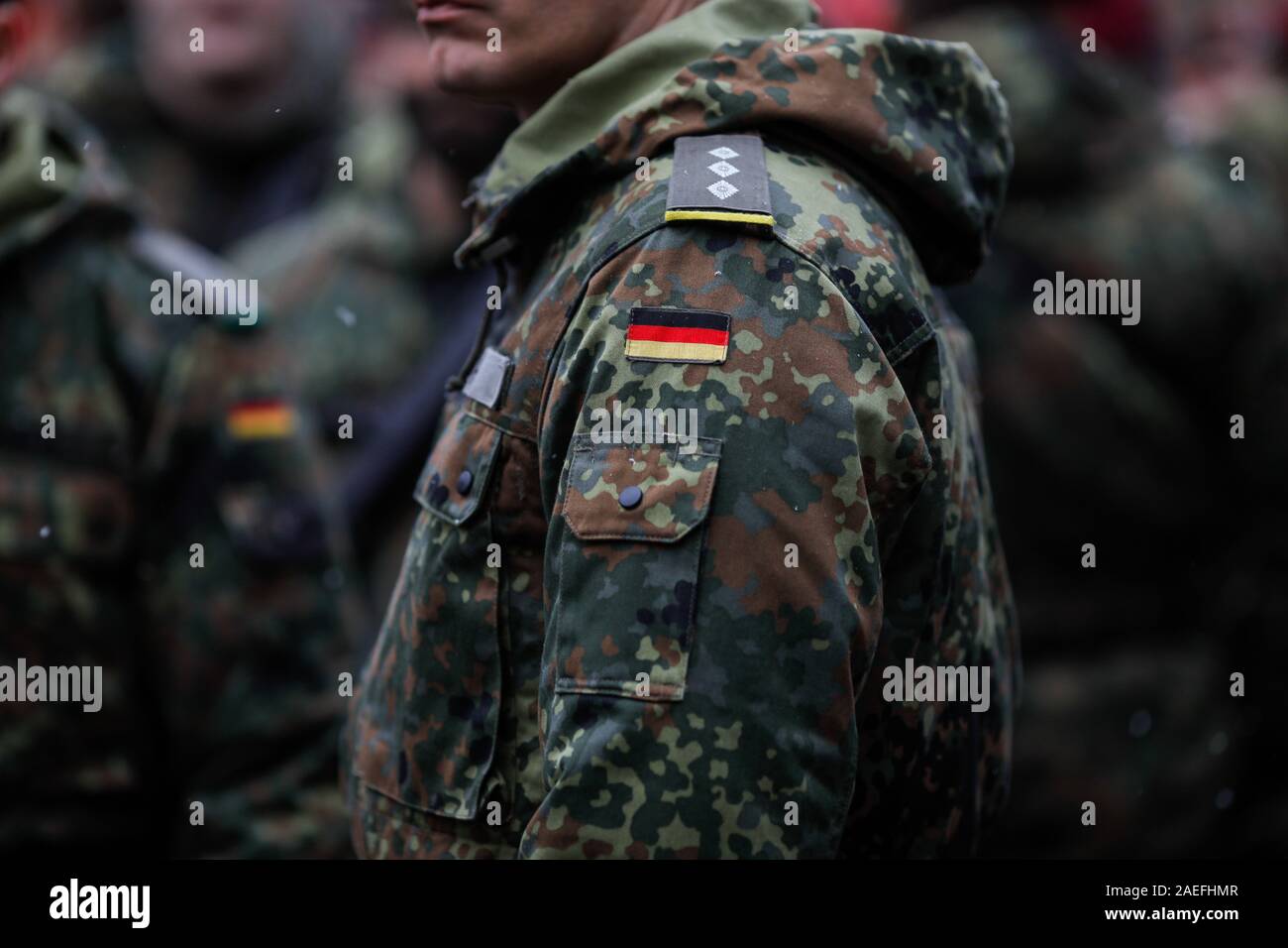 Details with the uniform and the flag on it of a German soldier taking part at the Romanian National Day military parade. Stock Photo