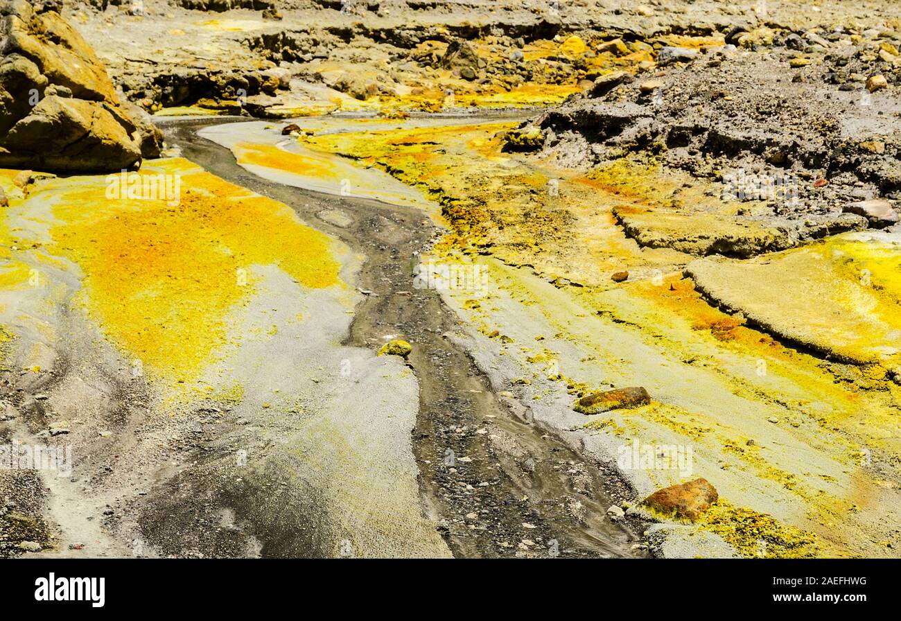 rugged landscape of yellow sulphur and steam of the Whakaari / White Island active volcano in New Zealand Stock Photo