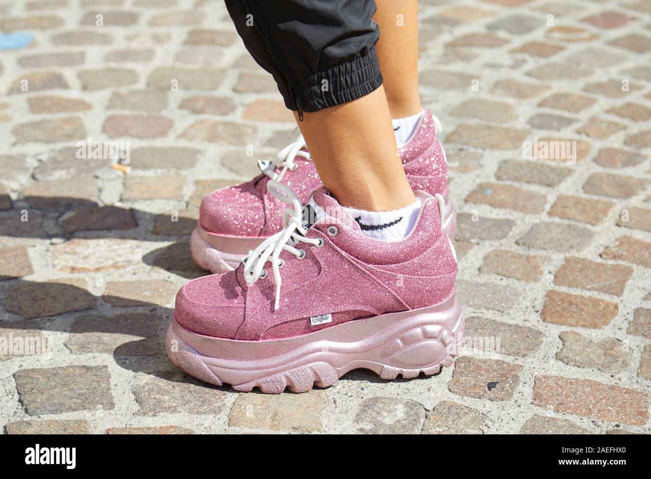 MILAN, ITALY - SEPTEMBER 21, 2019: Woman with pink glitter Buffalo sneakers  and Nike socks before Msgm fashion show, Milan Fashion Week street style  Stock Photo - Alamy