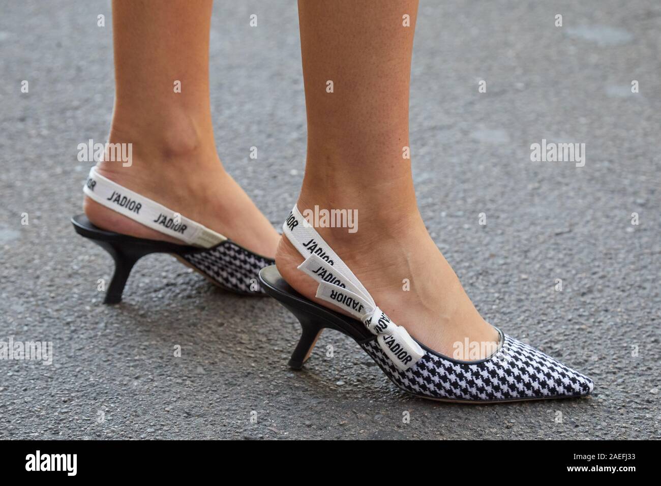 MILAN, ITALY - SEPTEMBER 21, 2019: Woman with Dior houndstooth shoes before Ermanno Scervino fashion show, Milan Fashion Week street style Stock Photo