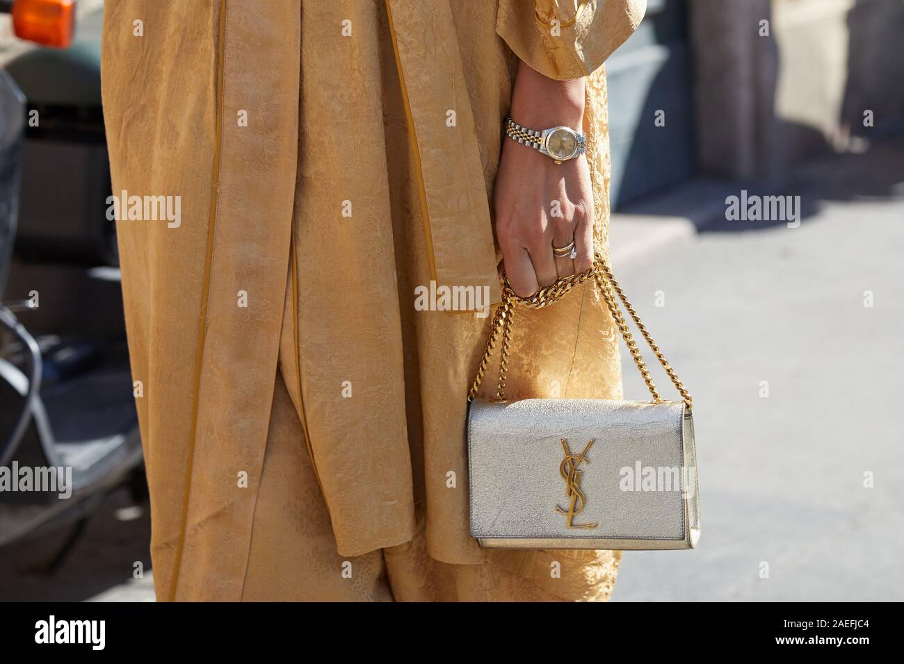 MILAN, ITALY - SEPTEMBER 21, 2019: Woman with golden dress, silver Yves  Saint Laurent bag and Rolex watch before Ermanno Scervino fashion show,  Milan Stock Photo - Alamy