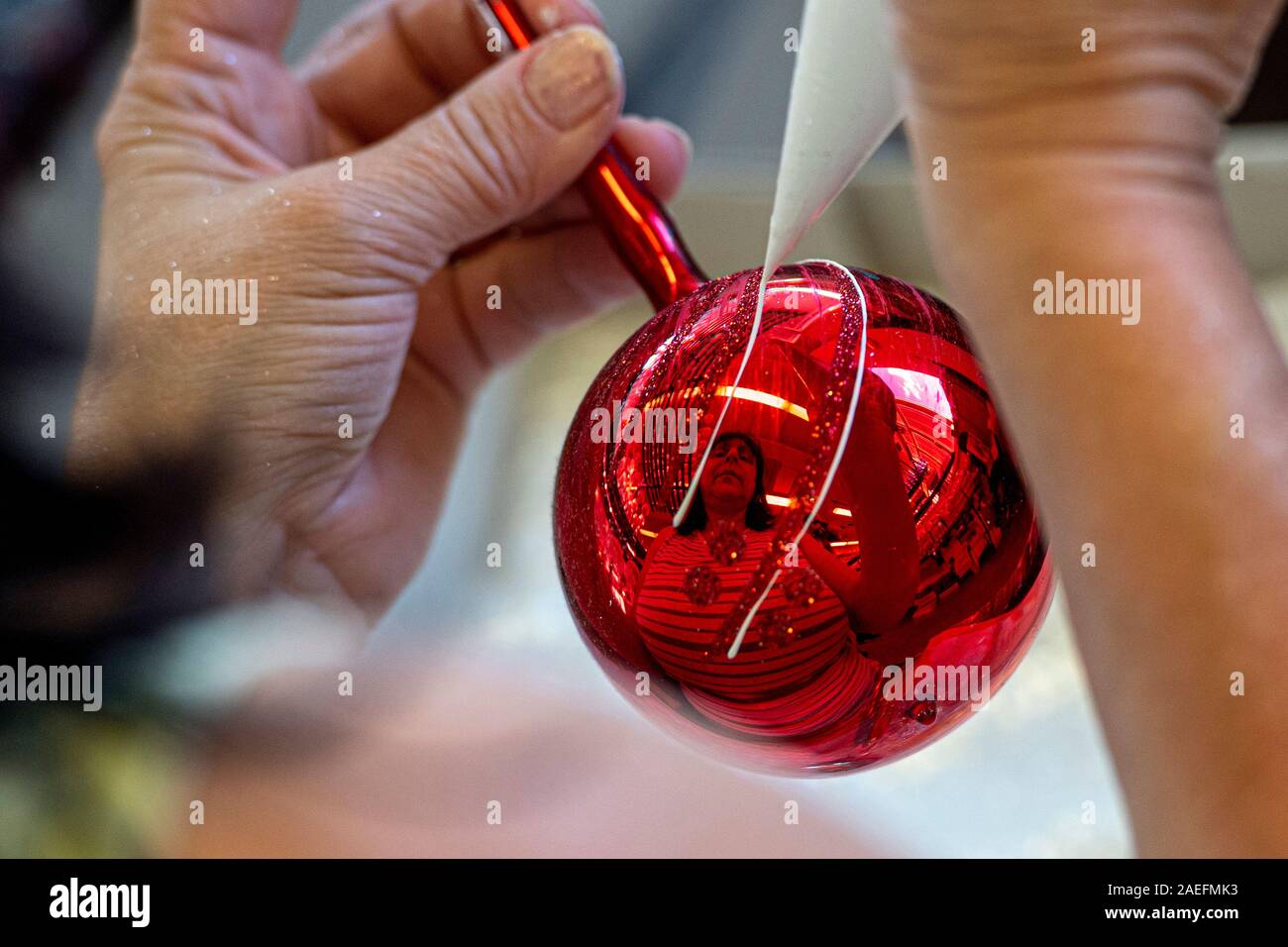 Worker completes glass ornaments in Vanocni ozdoby (Christmas ornaments)  factory, Dvur Kralove nad Labem, on Tuesday, December 3, 2019. Vanocni  ozdoby is the biggest manufacturer of hand-blown and painted glass  Christmas tree