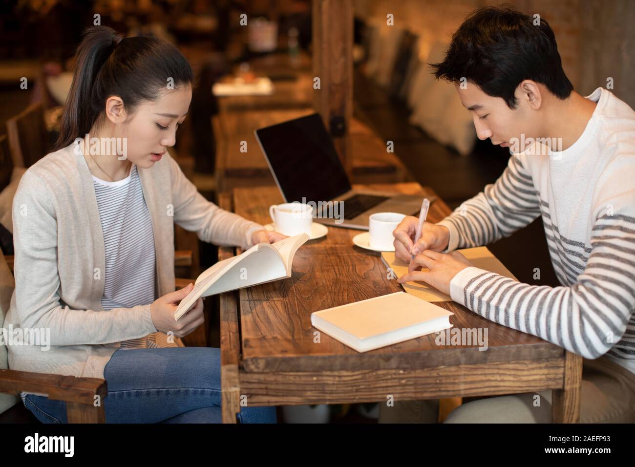 Young university students studying in coffee shop Stock Photo Alamy