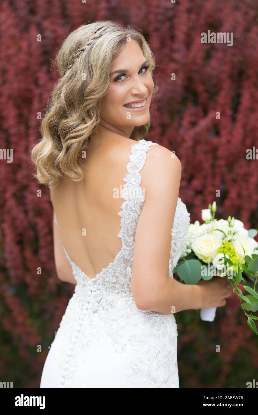 Wedding. Beautiful bride in white dress holding wedding bouquet Stock ...