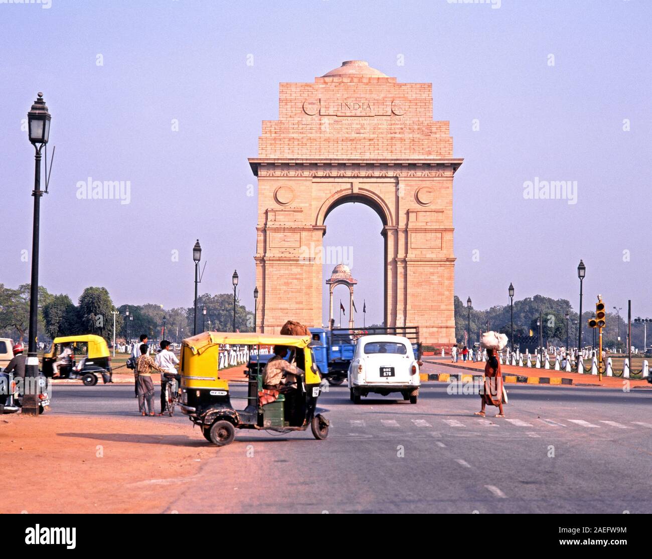 View of India Gate with local people and traffic in the foreground, Delhi, Delhi Union Territory, India. Stock Photo