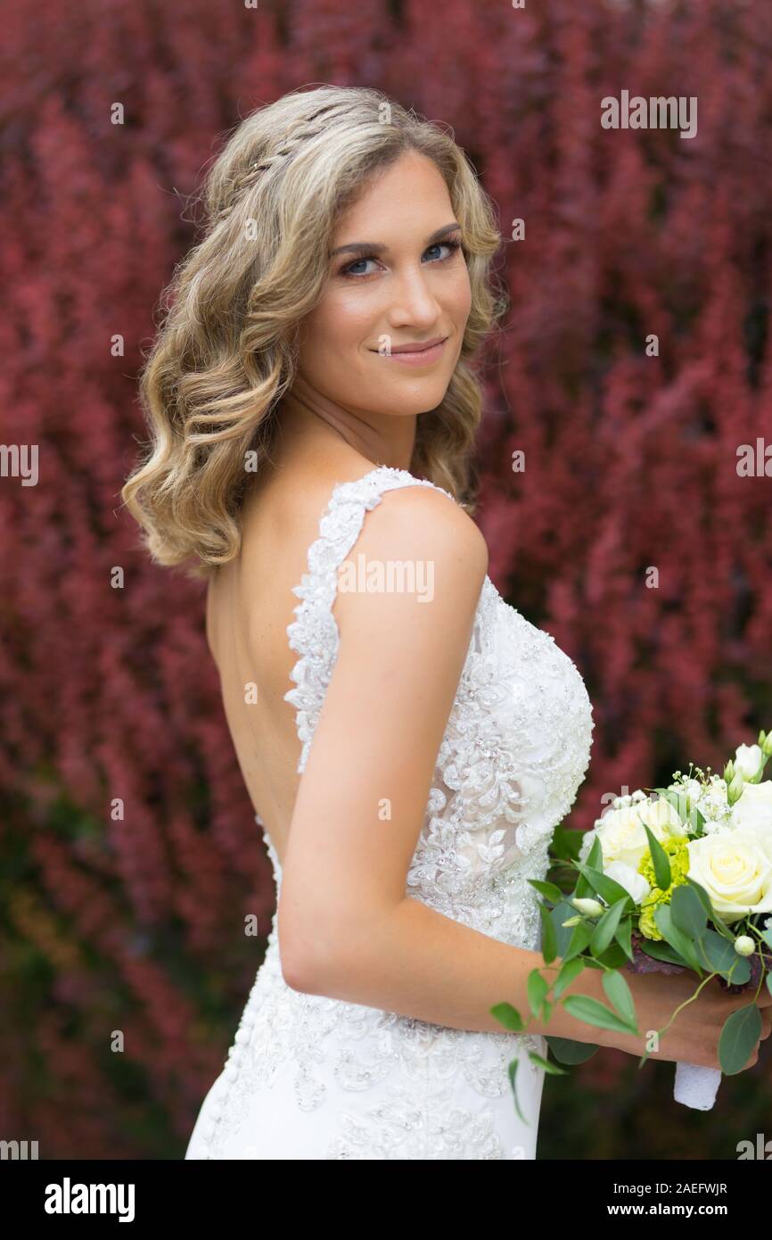 Wedding. Beautiful bride in white dress holding wedding bouquet Stock ...