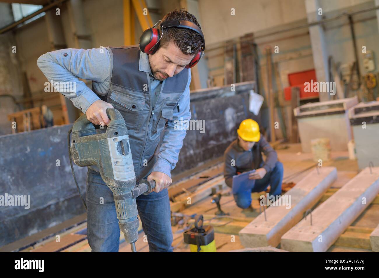 construction worker using hammer drill Stock Photo Alamy