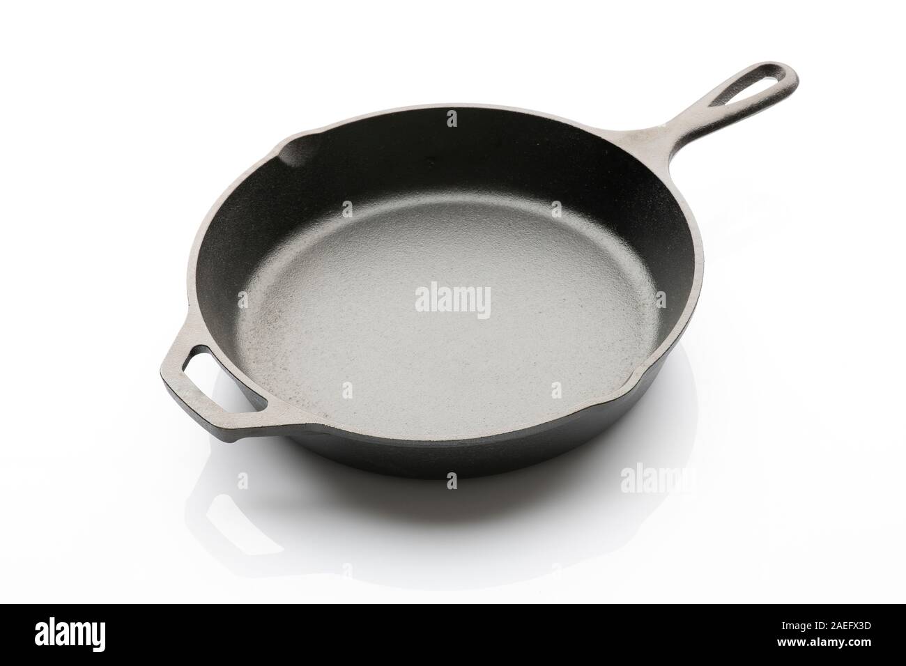 Side View of Seasoned Cast Iron Skillet on White Background Stock Photo