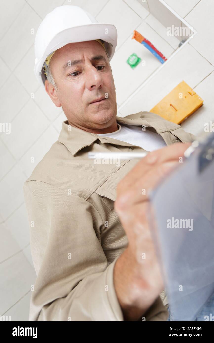 an architect writing on clipboard Stock Photo Alamy