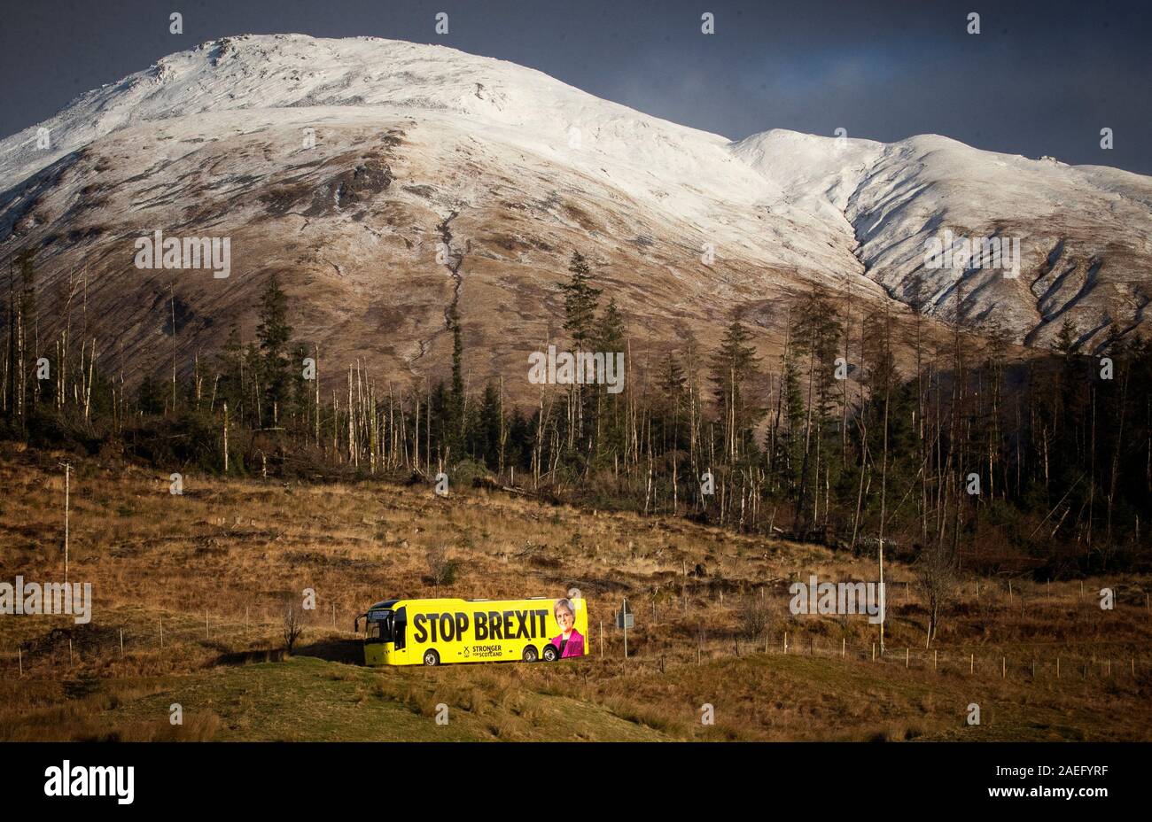The SNP campaign bus travels along the A82 near Tyndrum in the Highlands during its tour of Scotland in the final week of the General Election campaign. Stock Photo