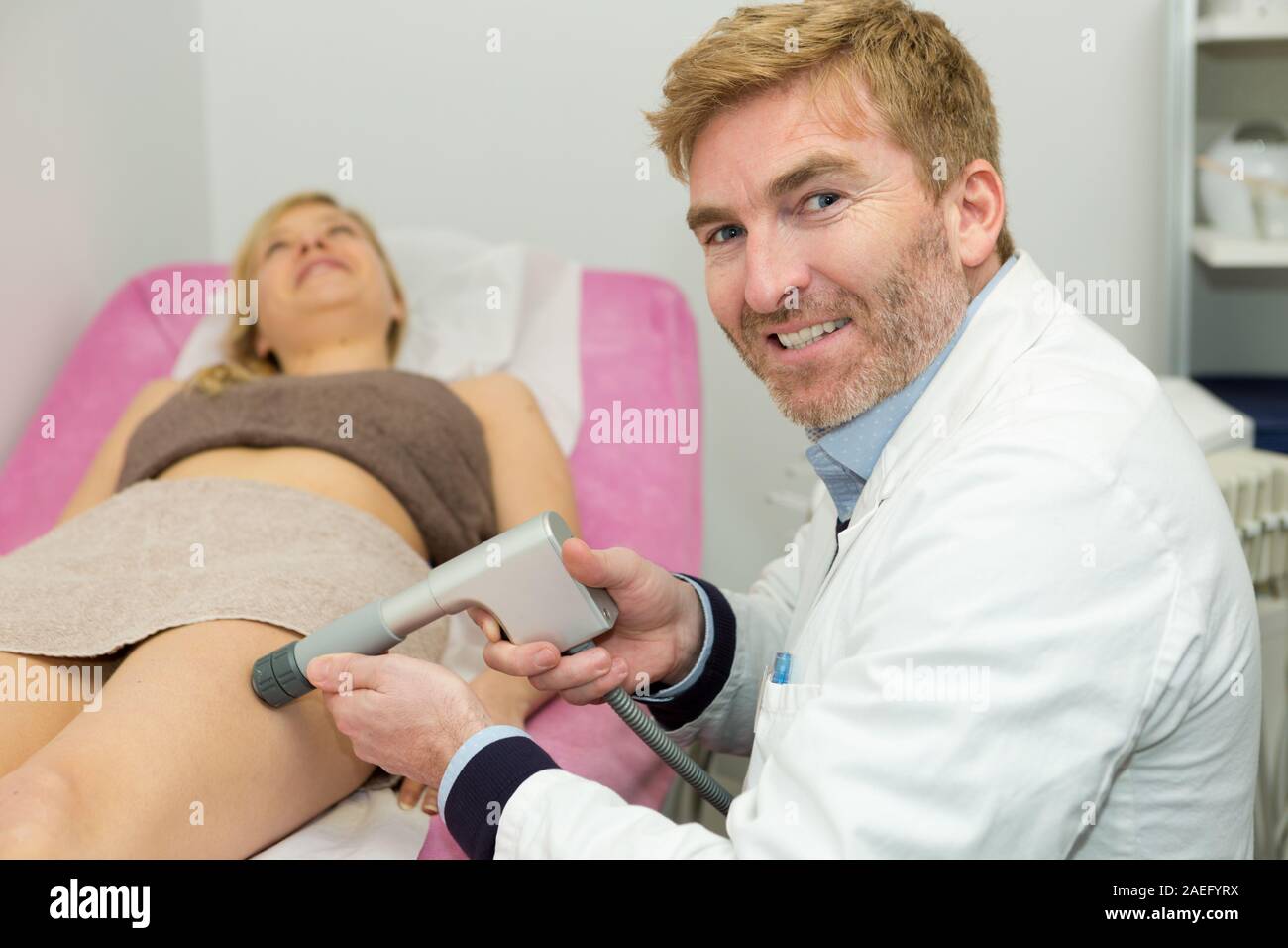 doctor treating the womans varicose in the hospital Stock Photo