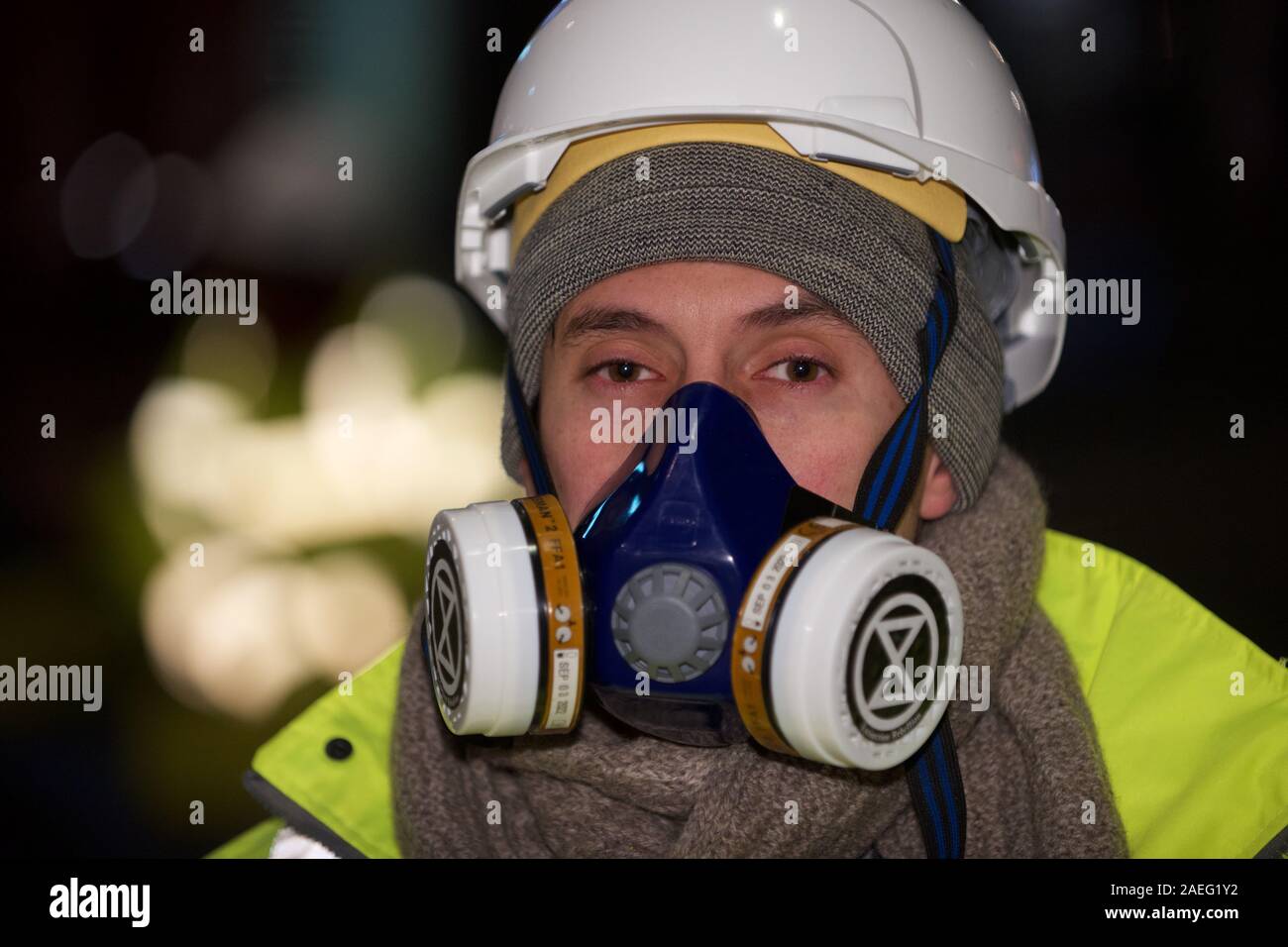 London, UK. 09th Dec, 2019. Extinction Rebellion 'Air That We Grieve' protest protester launched a pre-dawn action in Central London to protest illegal air quality levels in the capital. Dressed as highway maintenance workers, they blocked Cranbourne St and glued themselves to concrete blocks also glued to the road Credit: Gareth Morris/Alamy Live News Stock Photo