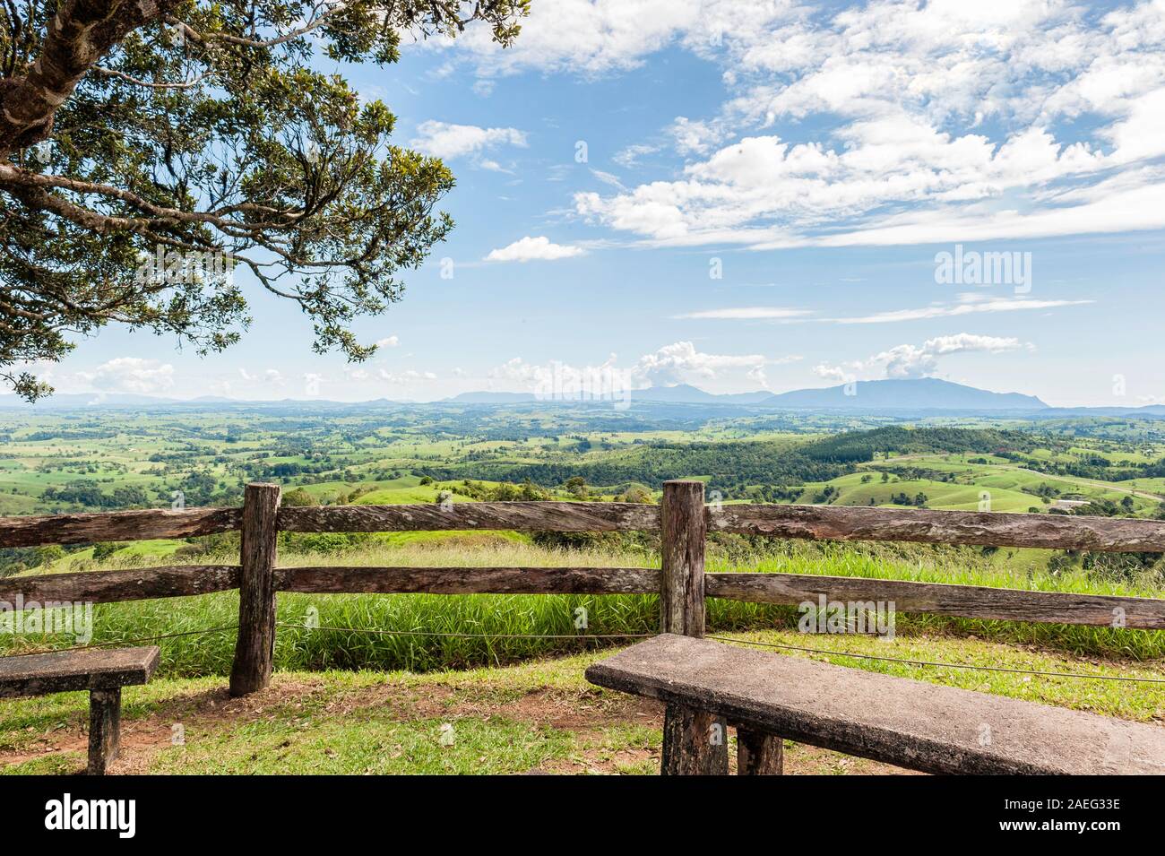 Tourist hotspot, hand hewn wooden fence and benches overlooking the beautifully fertile Millaa Millaa and Malanda farmlands. Stock Photo