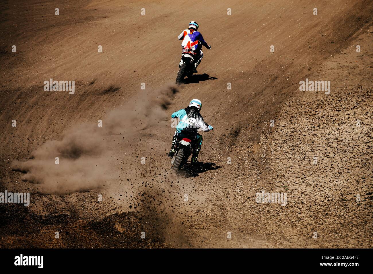 back two motocross riders in race ground track Stock Photo - Alamy